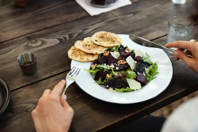 person getting ready to eat salad