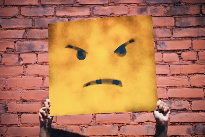 angry face poster being held up
