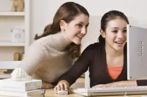 mother engaging with child on computer to prevent cyberbullying