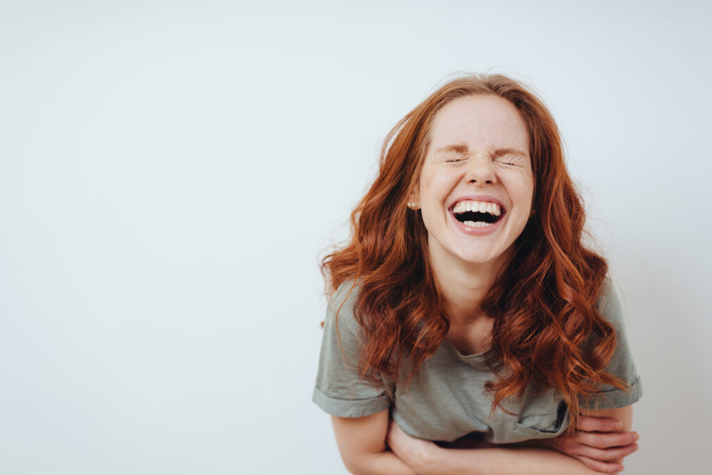 A woman laughing as part of an extremely fun vagus nerve exercise.