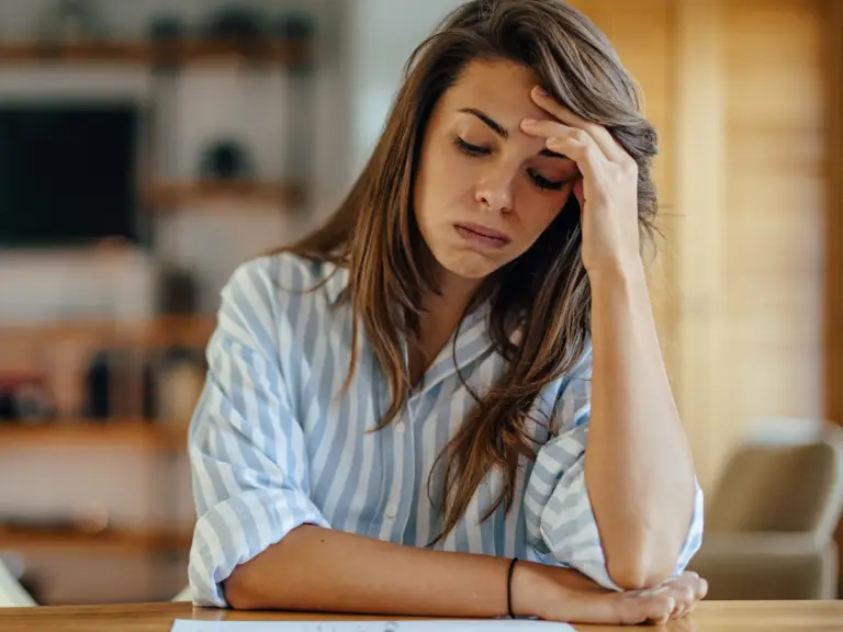 A woman stressed and frustrated because she doesn't know how to stop overthinking