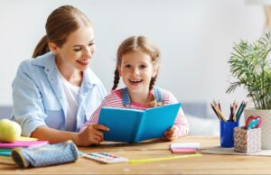 A mother helping her daughter decide which journal prompt for kids she wants to write about.