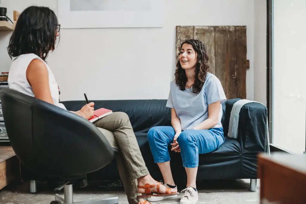 A picture of a woman talking to a therapist showing that therapy may help with the struggle.
