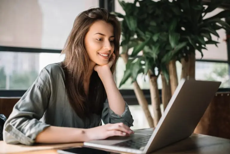 a young brunette woman smiling during her video counseling session, feeling relieved from her online anxiety support.