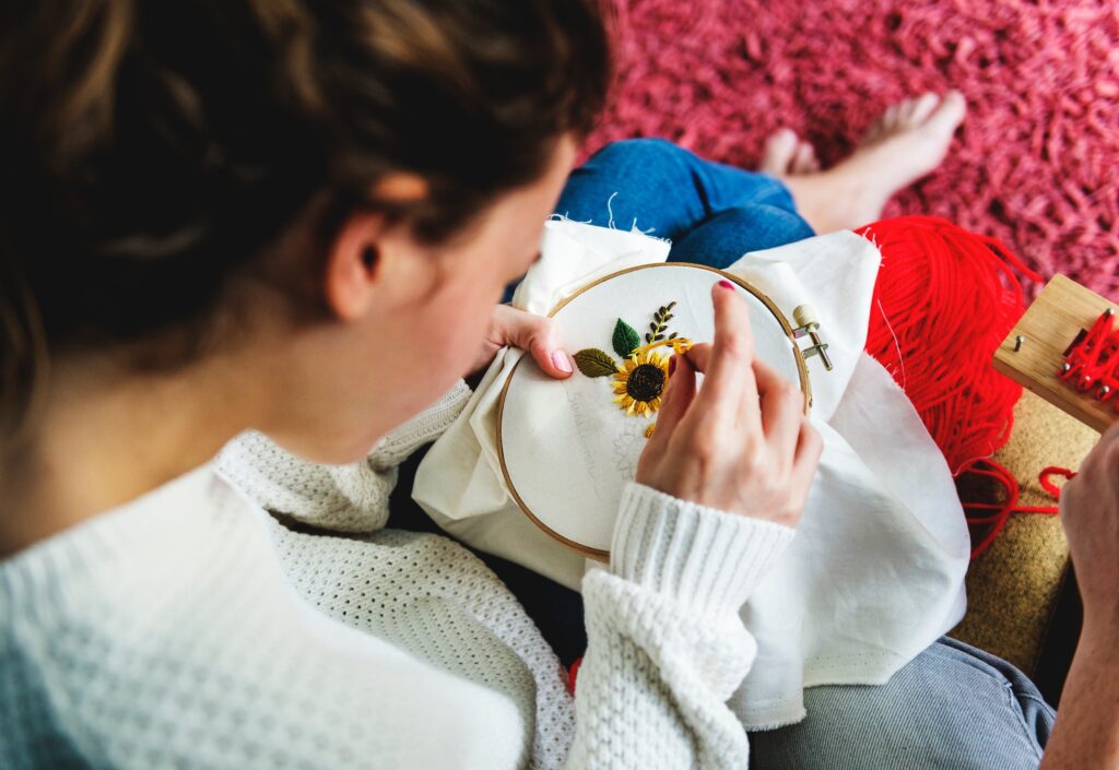 How to overcome codependency in time to save your relationship A young woman embroidering a floral patter.