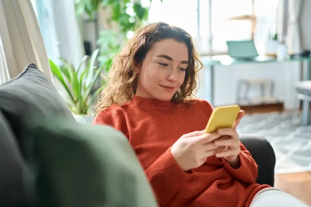 How to stop overreacting and finally gain control over your emotions A young curly haired woman talking to her online counselor for support for emotional resilience.