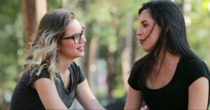 Two women in conversation, addressing a conflict instead of engaging in conflict avoidance.