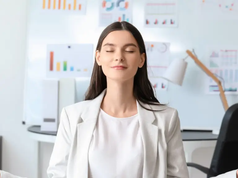 A woman with her eyes closed who is practicing staying calm in any situation