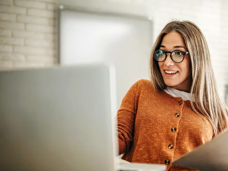 A young woman researching popular anxiety treatment methods on her laptop