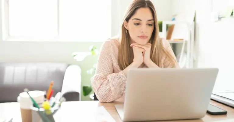 Woman looking up how to overcome depression on her laptop
