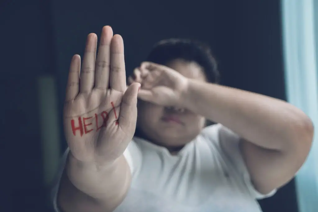 Limerence vs Love: Understanding The Difference And How To Break The Cycle (8 Signs) Woman holding out hand asking for help because she's trapped between limerence and love