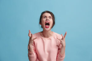 A distressed woman mid-emotional outburst, illustrating the crash out meaning as a sudden, intense release of built-up emotions.