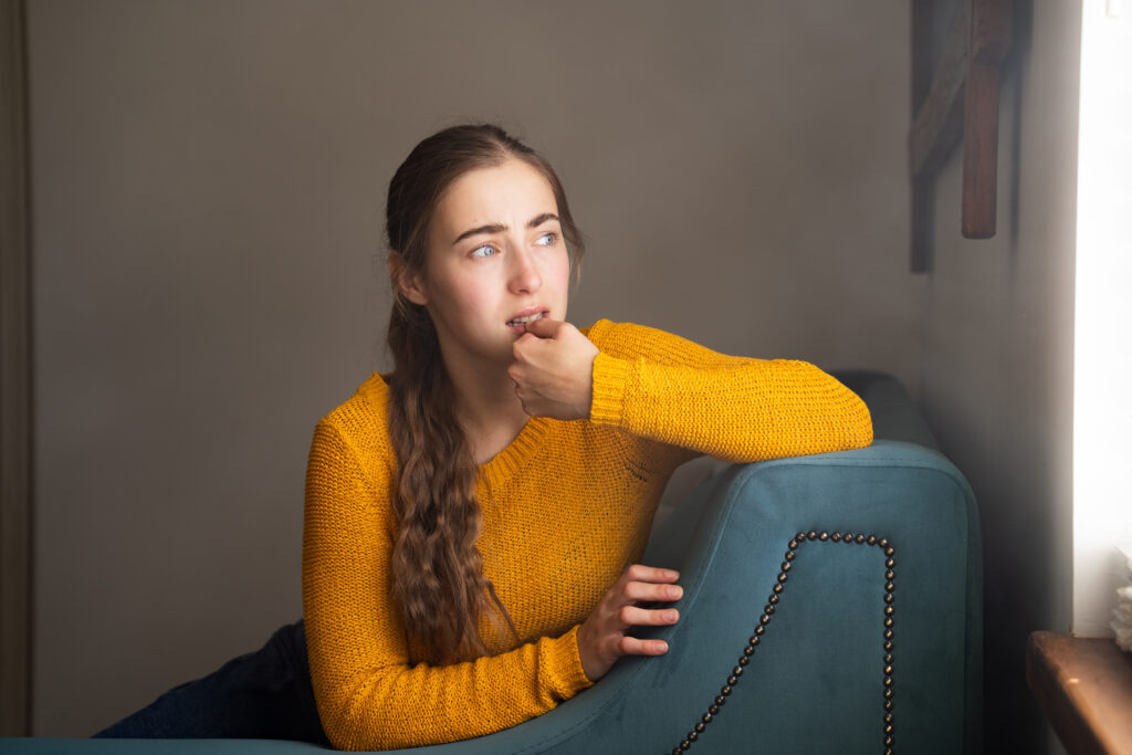 A woman looking out a window and thinking about the unintended consequences of the burnt toast theory.