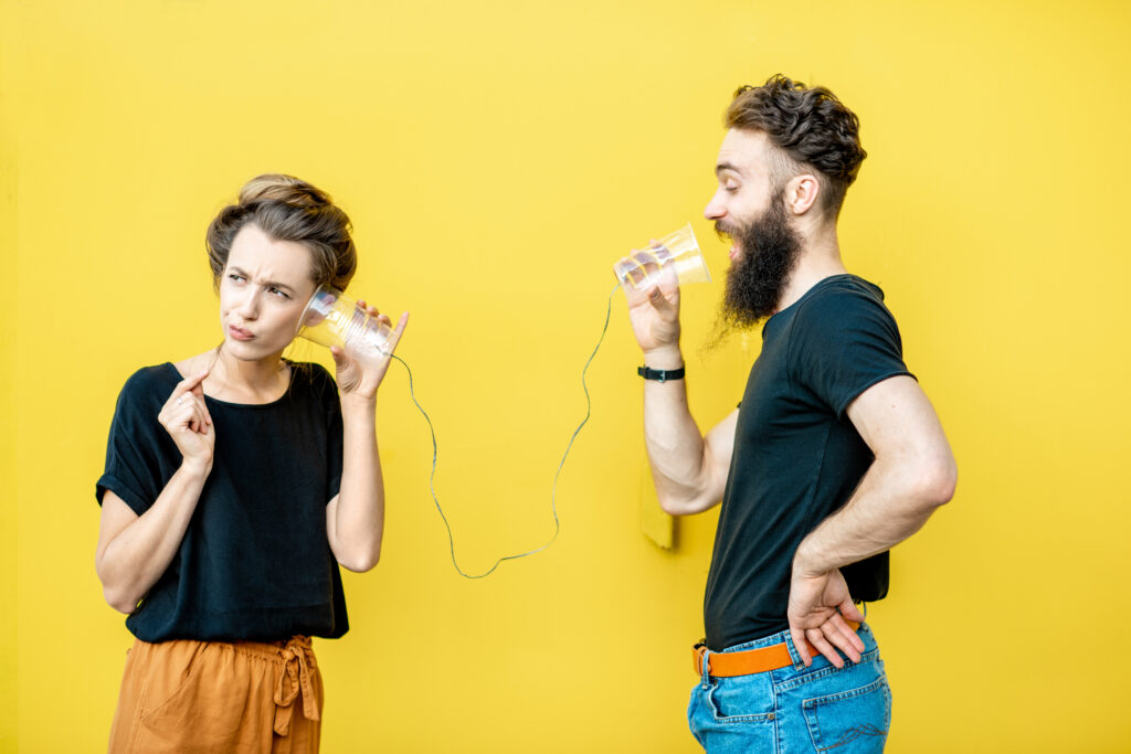 Man and woman communicating healthy boundaries through cups and wires.