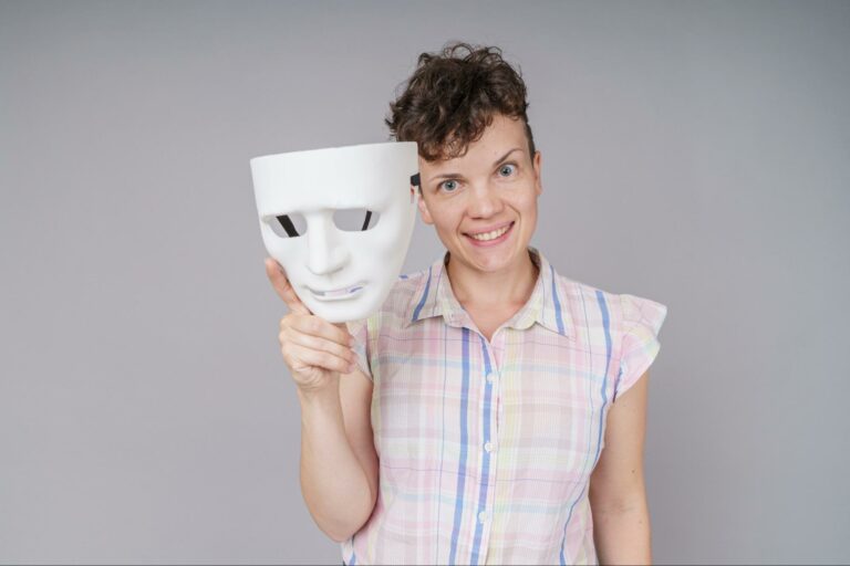 A woman smiling because she is learning to drop the mask of main character syndrome.