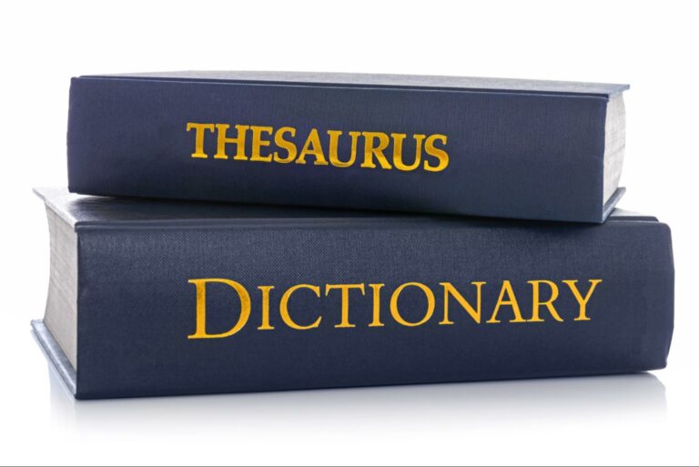 A dictionary and a thesaurus represent researching words to describe emotions.