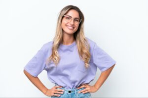 A woman who has learned how to build confidence, standing confidently with her hands on her hips.