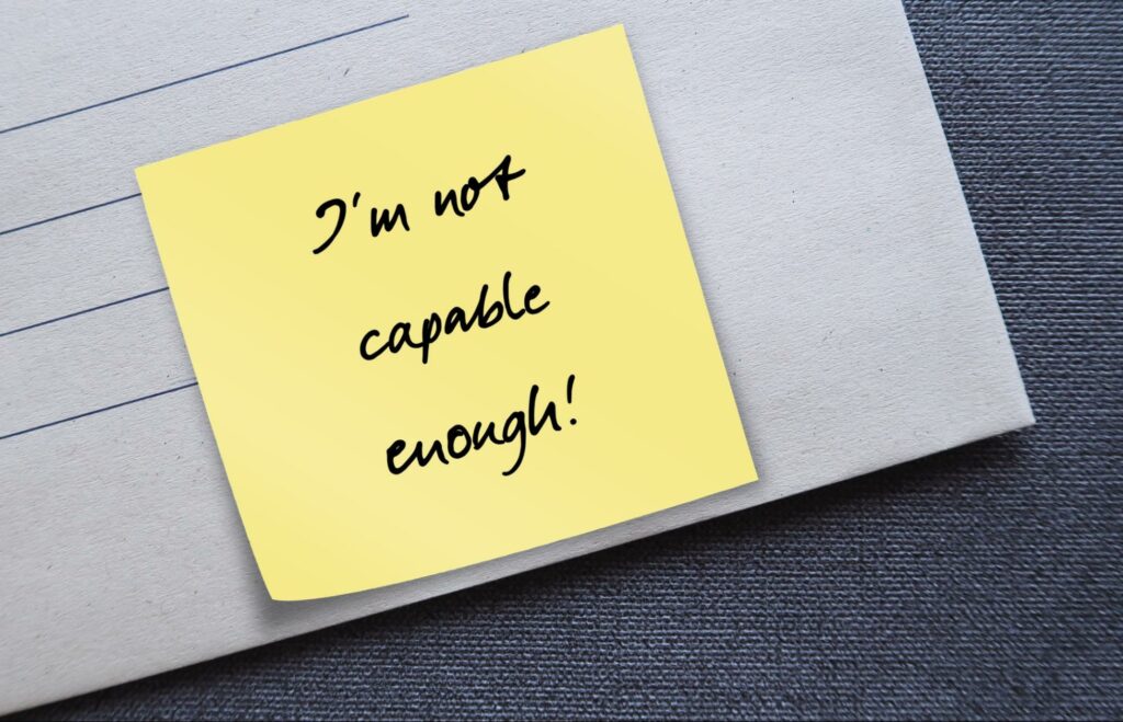 A sticky note that says “I’m not capable enough!” exemplifies one aspect of a lack of self confidence.
