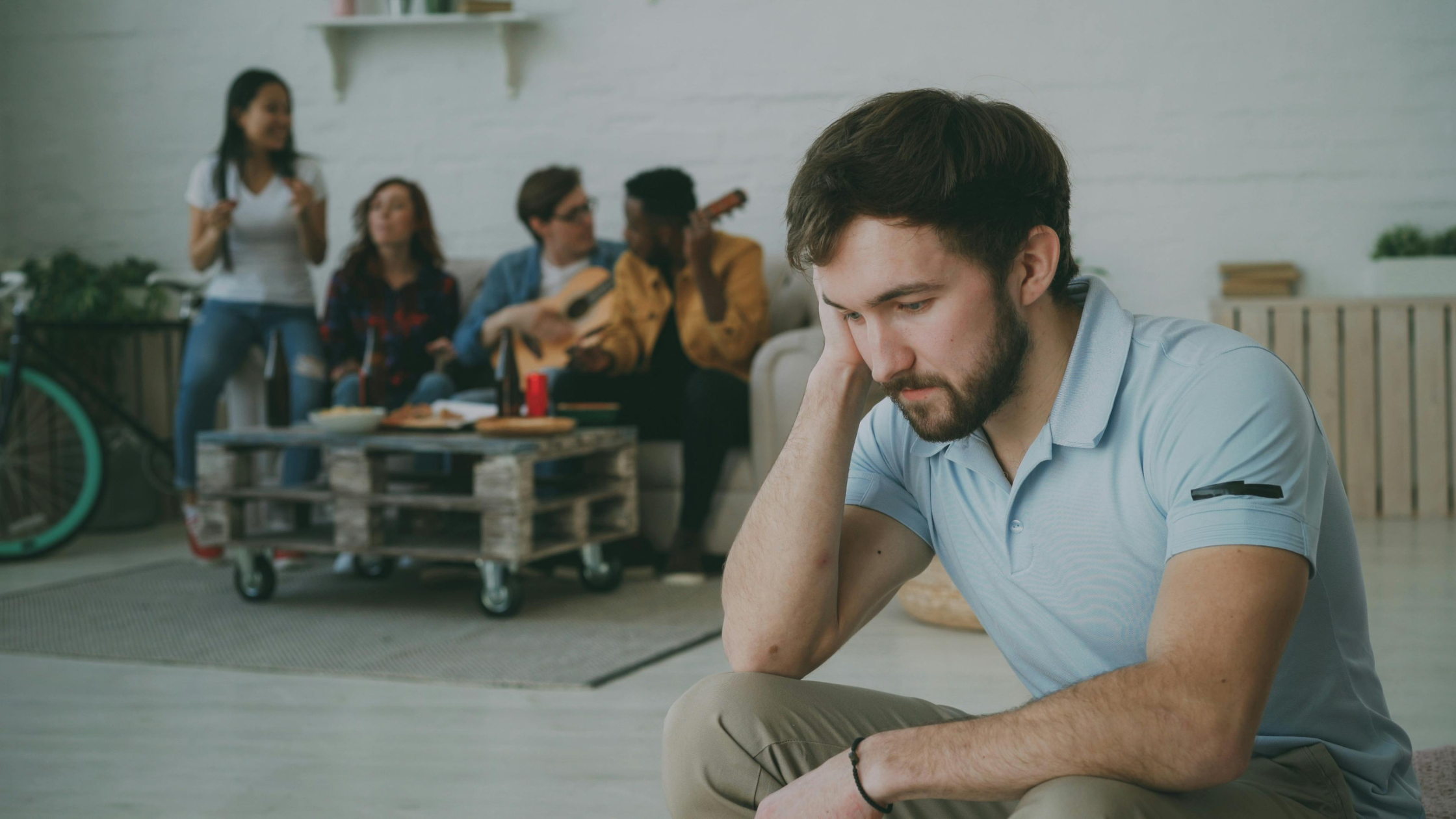 Man looking conflicted and emotionally overwhelmed in quiet setting