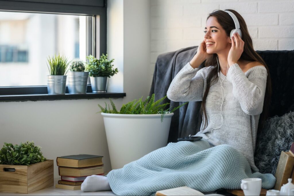 A woman listening to music to calm her breathing.