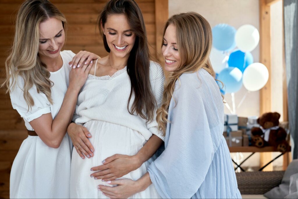 Power dynamics in relationships, represented by three women preparing for a new baby.