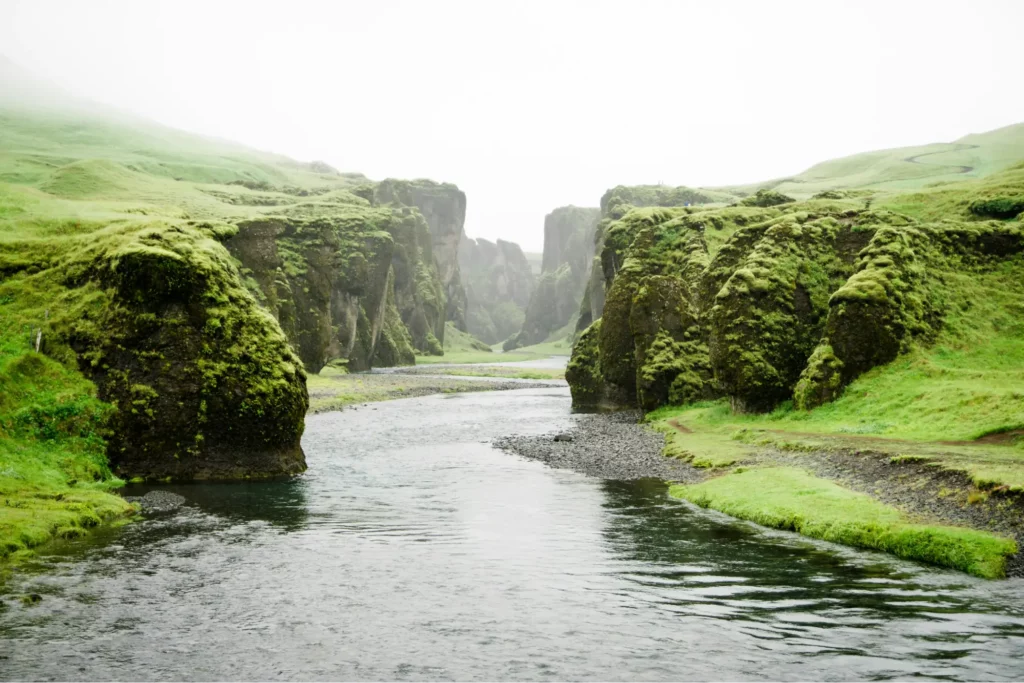 A river with clear banks on either side, representing the ups and downs of self-esteem.