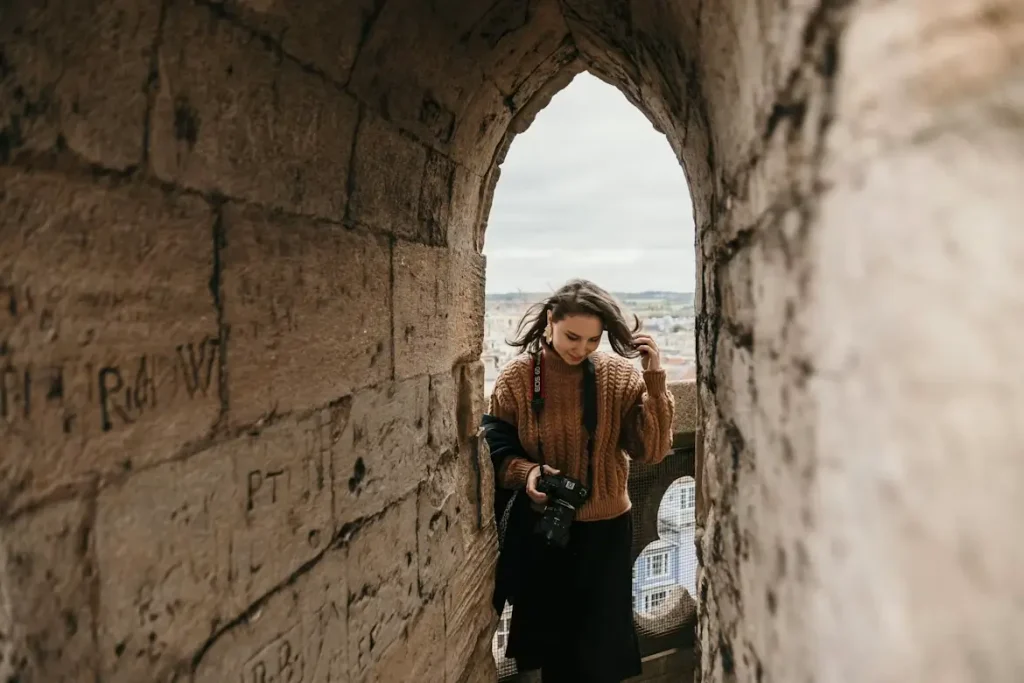 You can leave the tower of past relationship patterns that hurt you and explore the beautiful world waiting for you like the woman holding her camera on vacation here.