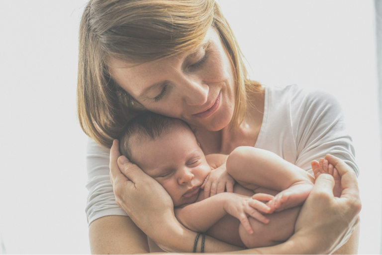 grandmother bonding with newborn grandbaby, setting him up for strong relationship attachment styles