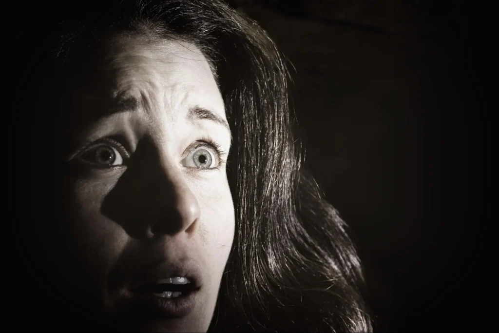 The face of a frightened woman represents the fears that you may struggle with if you have an anxious avoidant attachment.