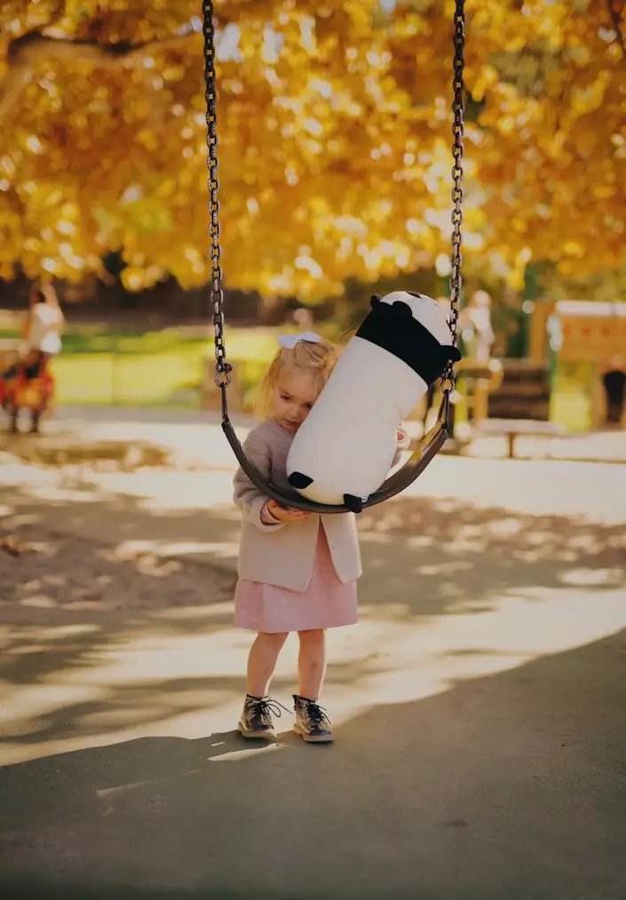 Getting off the metaphorical swing of fearful avoidant attachment is possible even though it can be disorienting and scary at first, as this girl is experiencing with her plush toy.