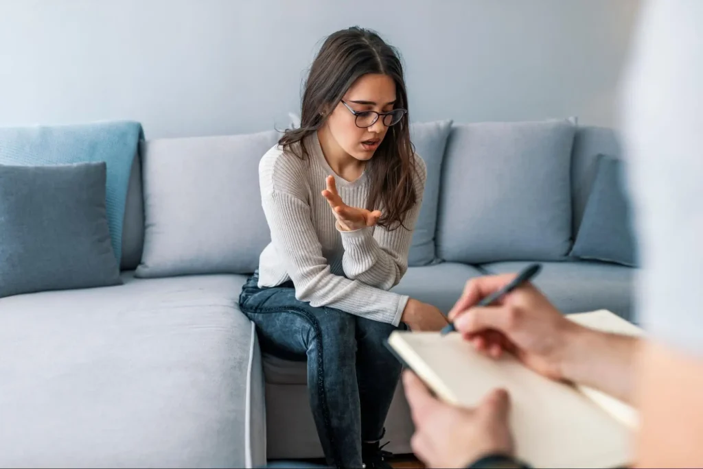 A young girl giving examples of vocal stimming adhd with her therapist during a session.