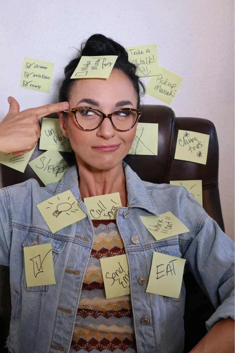 Makin Wellness Articles A young woman covered in sticky notes, representing different ADHD symptoms in women.