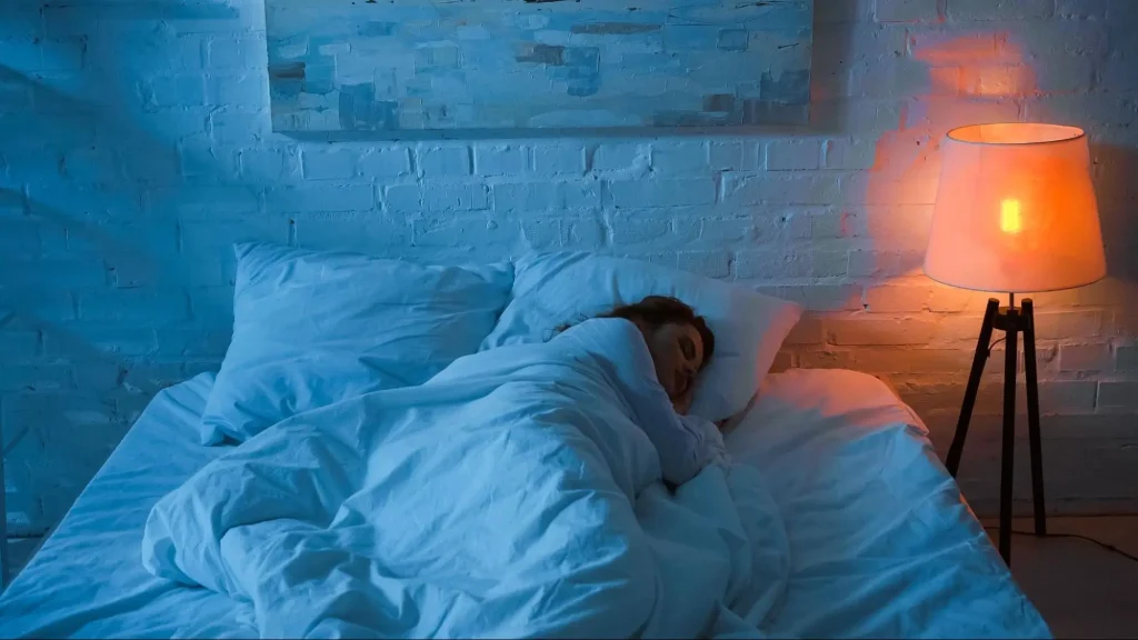 A woman peacefully sleeping in her apartment, free from ADHD sleep problems.