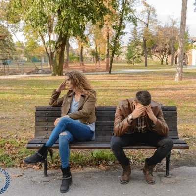 frustrated man and woman sitting on bench