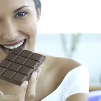 happy woman eating chocolate