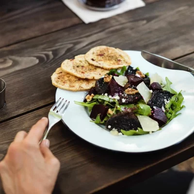 person getting ready to eat salad