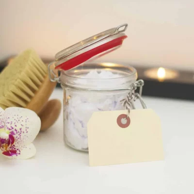 jar of bath essentials next to flower