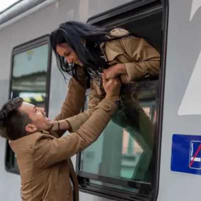 man and woman saying goodbye on train