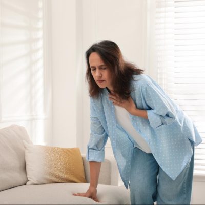 A woman in distress, desperately wondering how to tell if shortness of breath is from anxiety.