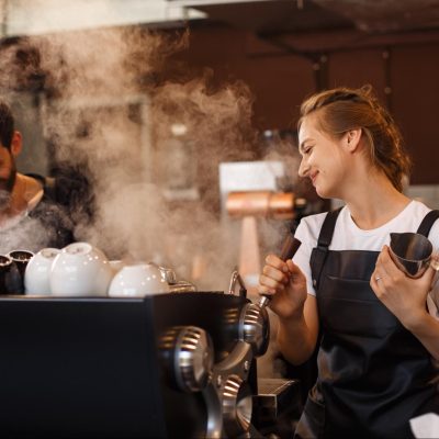 Male and female baristas as an example of power dynamics in relationships in a workplace setting.