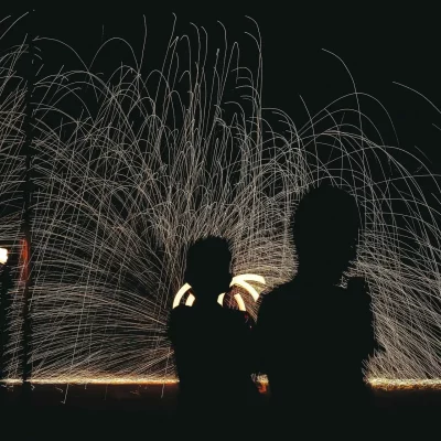 shadows of kids in front of fireworks