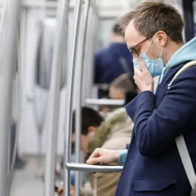 man with mask on subway