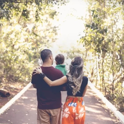 family walking down a wooded road