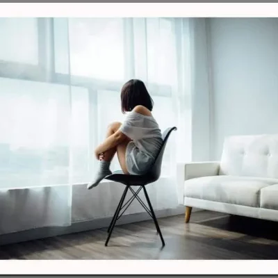 girl sitting in front of window during quarentine