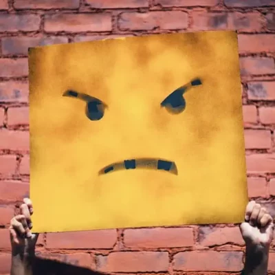 angry face poster being held up