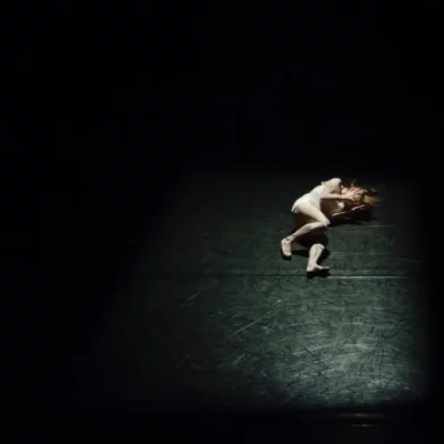 woman laying on floor in dark